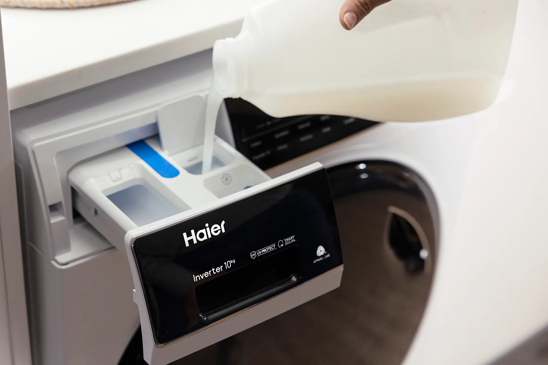 Liquid detergent being poured into washing machine