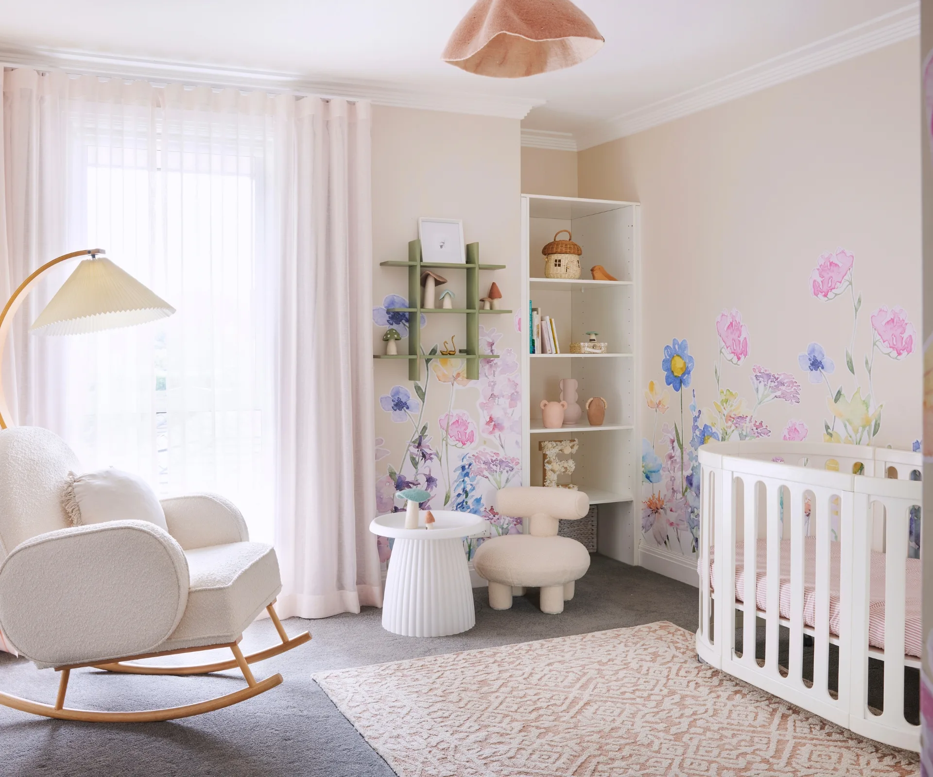 A pink girl's kids bedroom with floral wall stickers