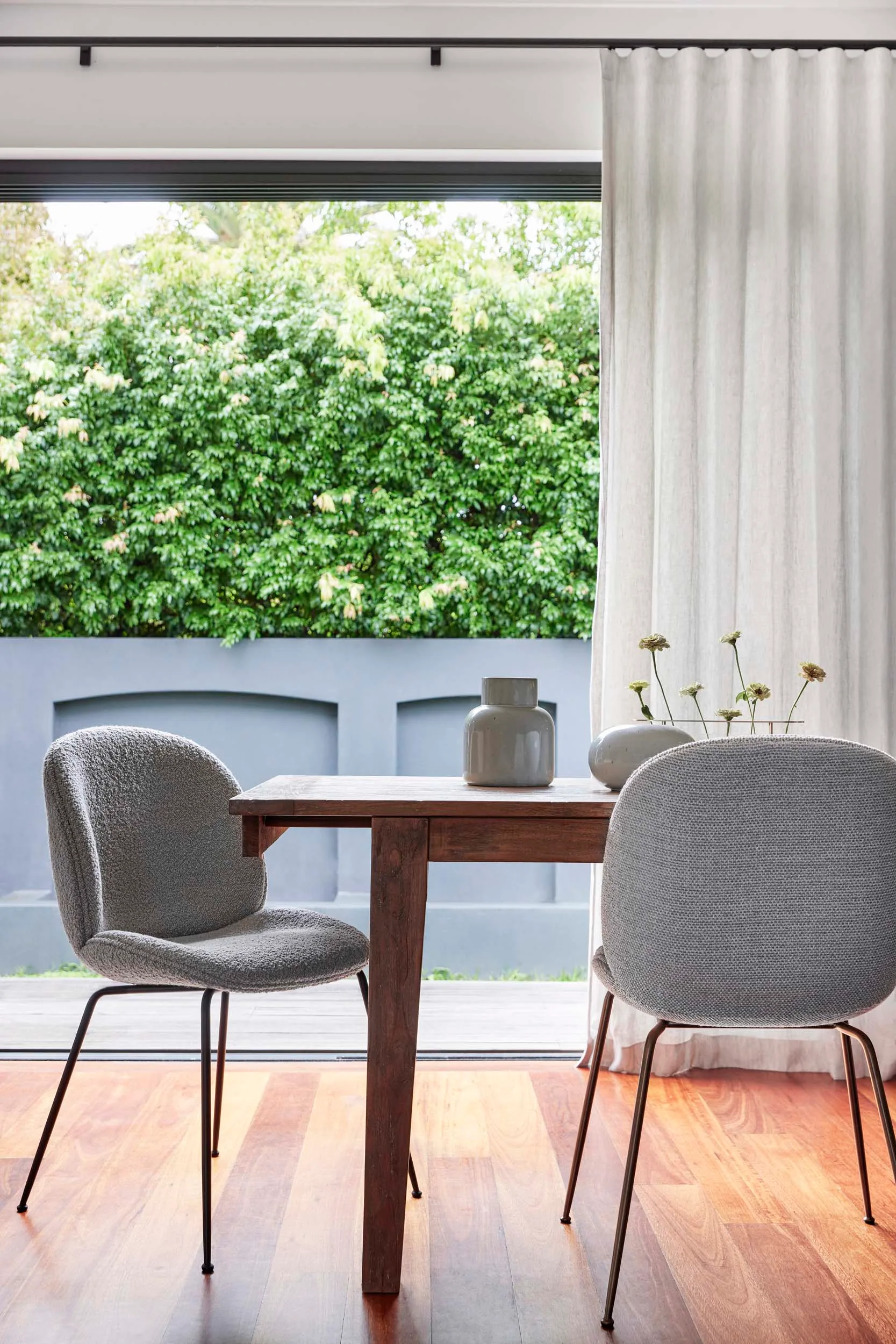 Grey fabric dining chairs around a wooden table