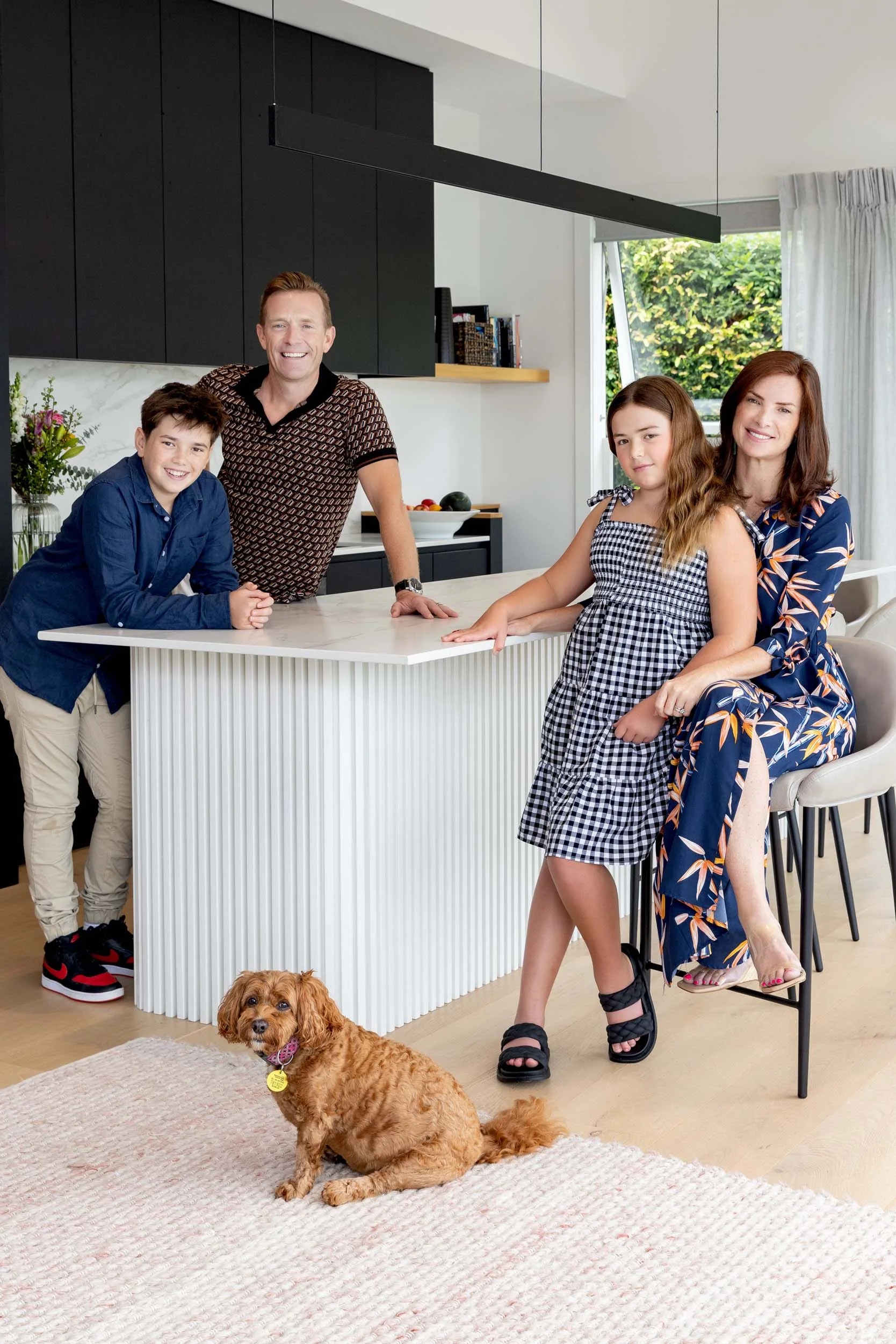 The Mount Eden renovation homeowners in the kitchen with their kids