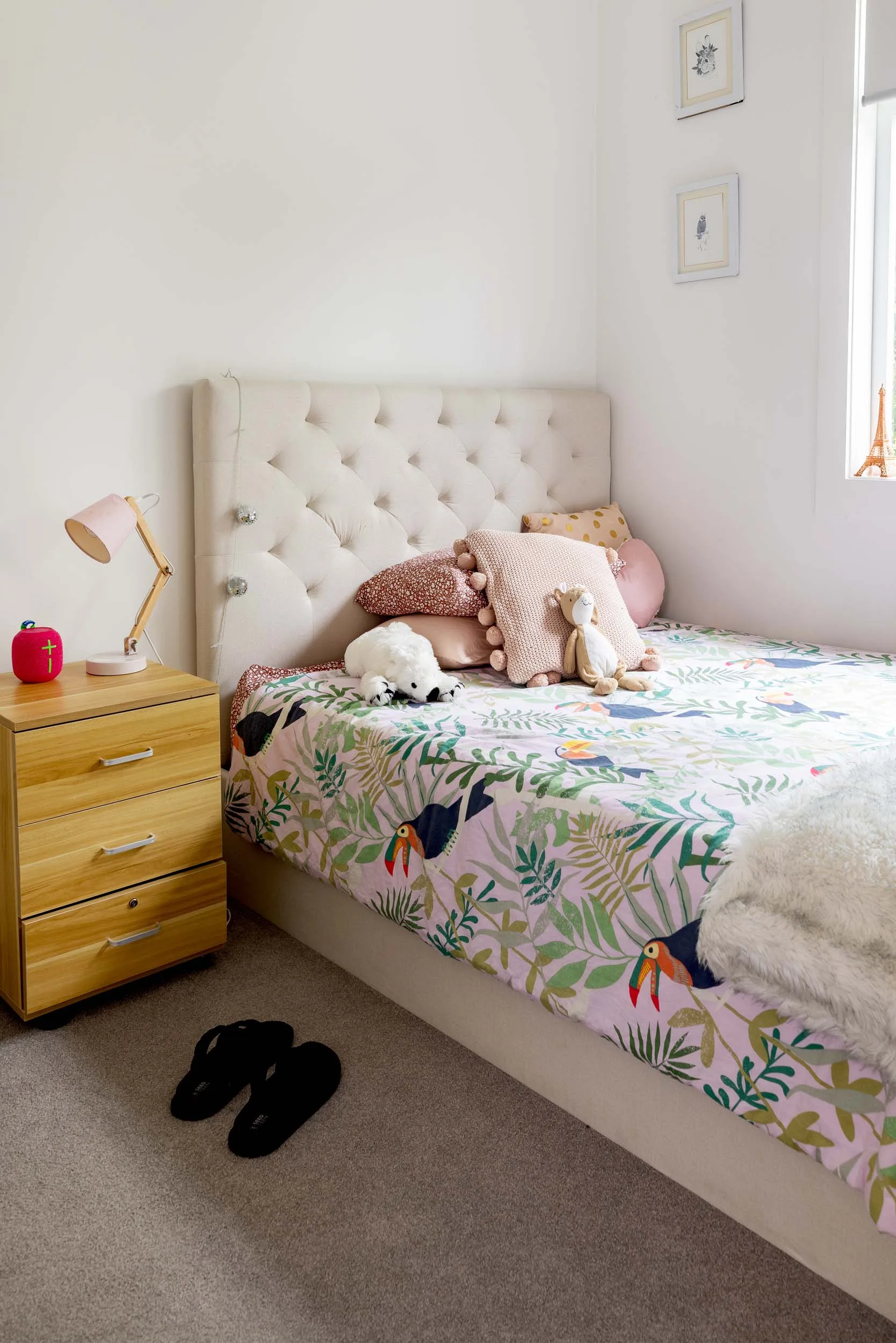 A kids bedroom with floral pink bedding