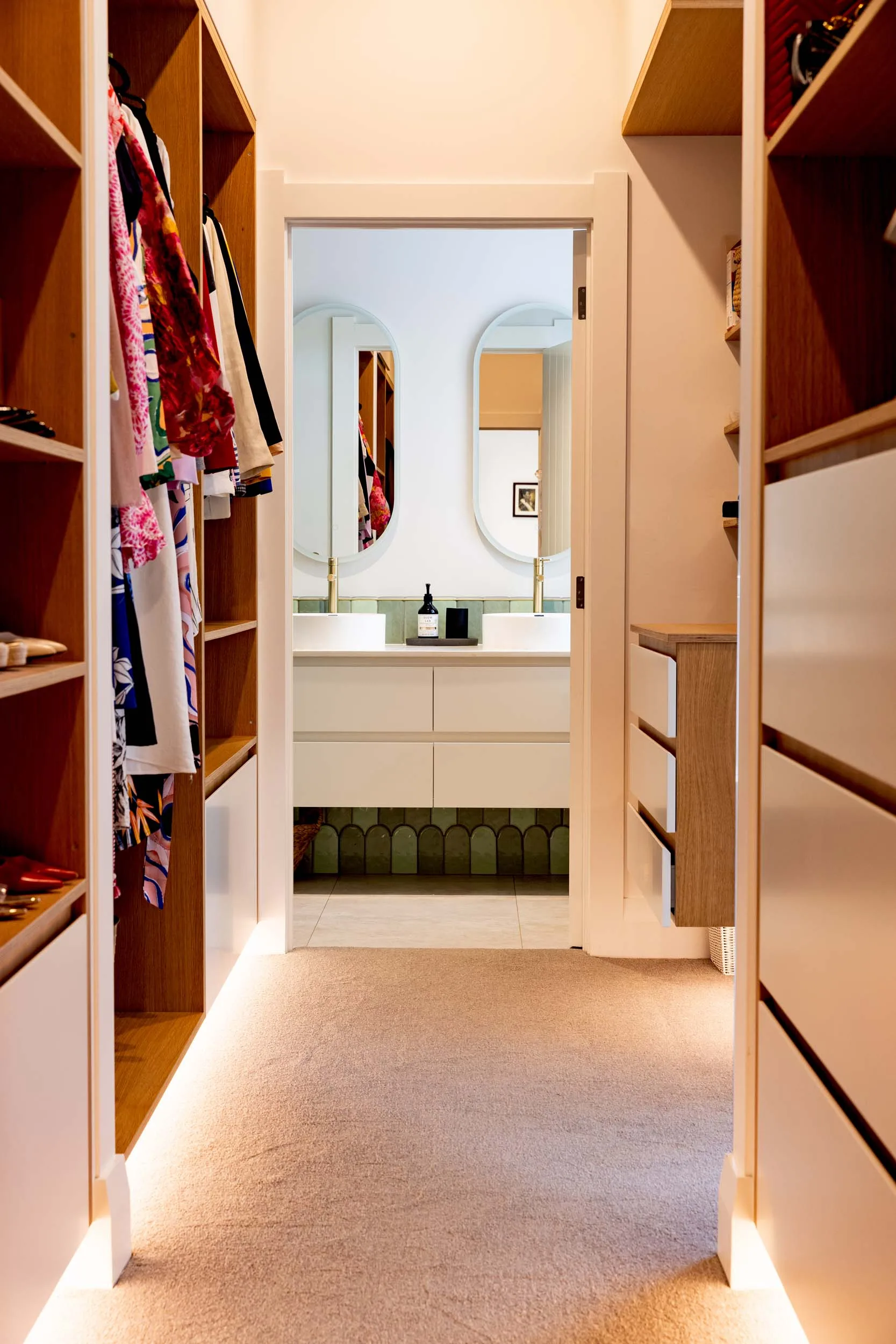 The walk-in wardrobe in the Mount Eden home's master bedroom with a view through to the ensuite after the renovation