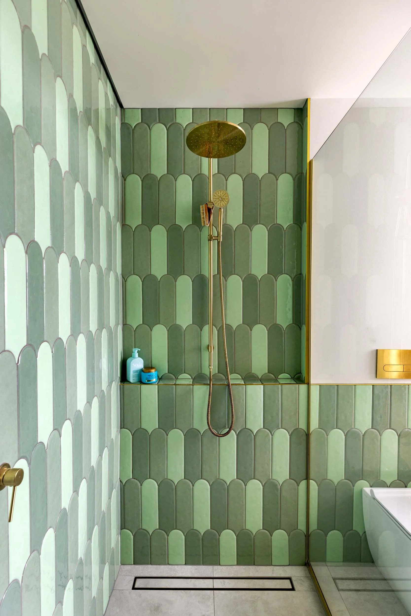 A golden shower with green arch-shaped tiles