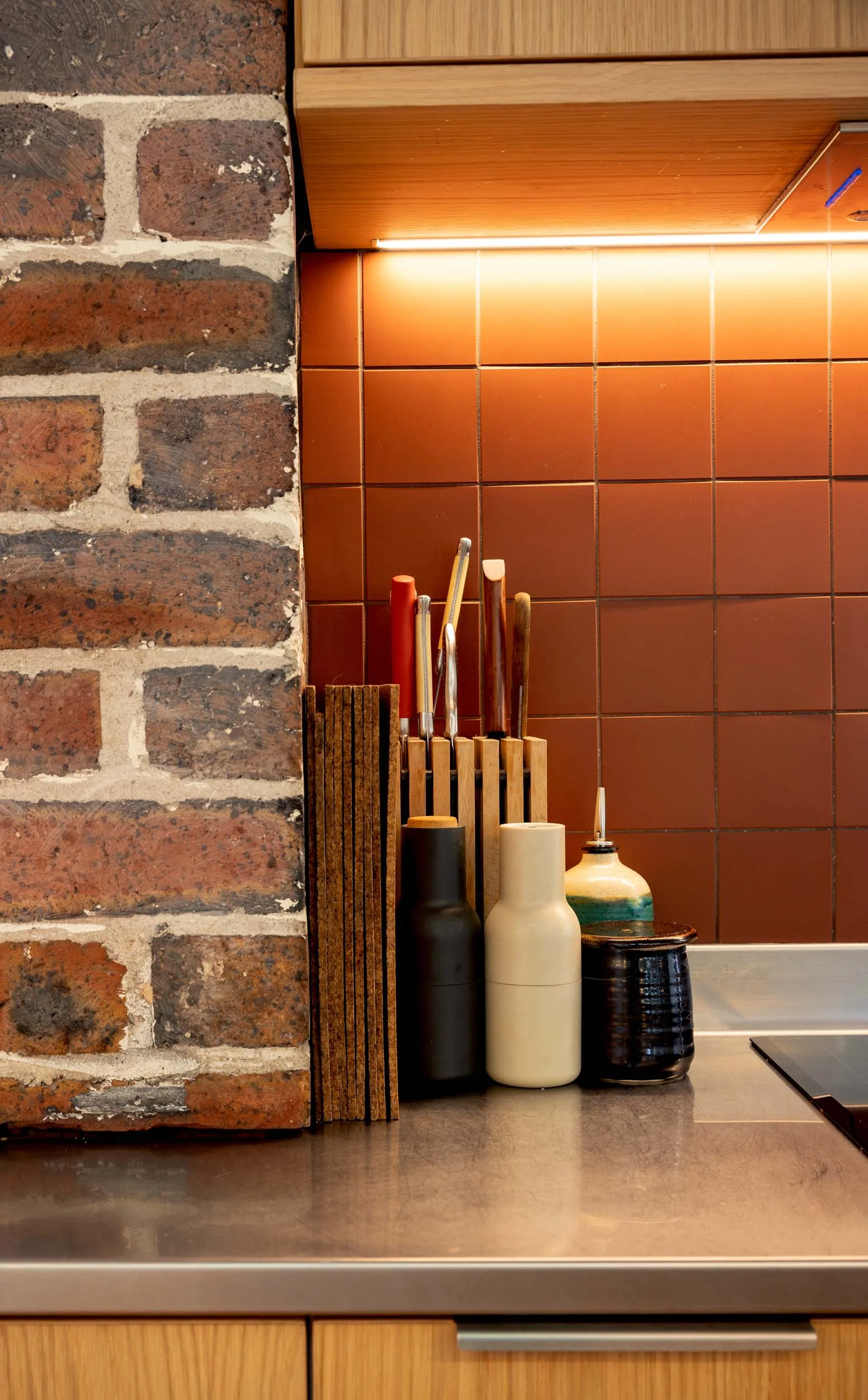 cutting boards and knives in the corner of the kitchen