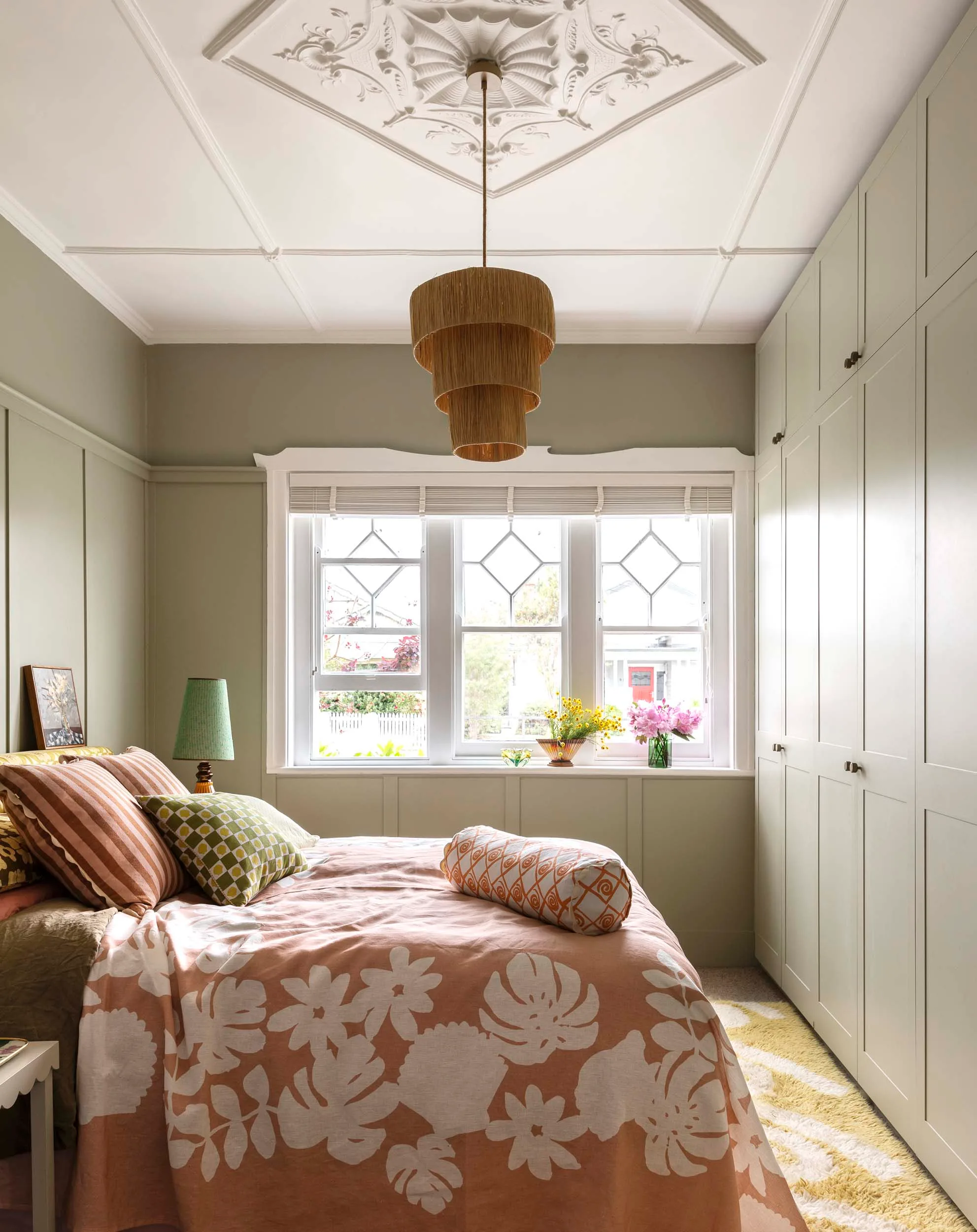 pink bedding in a green bedroom with a white roof