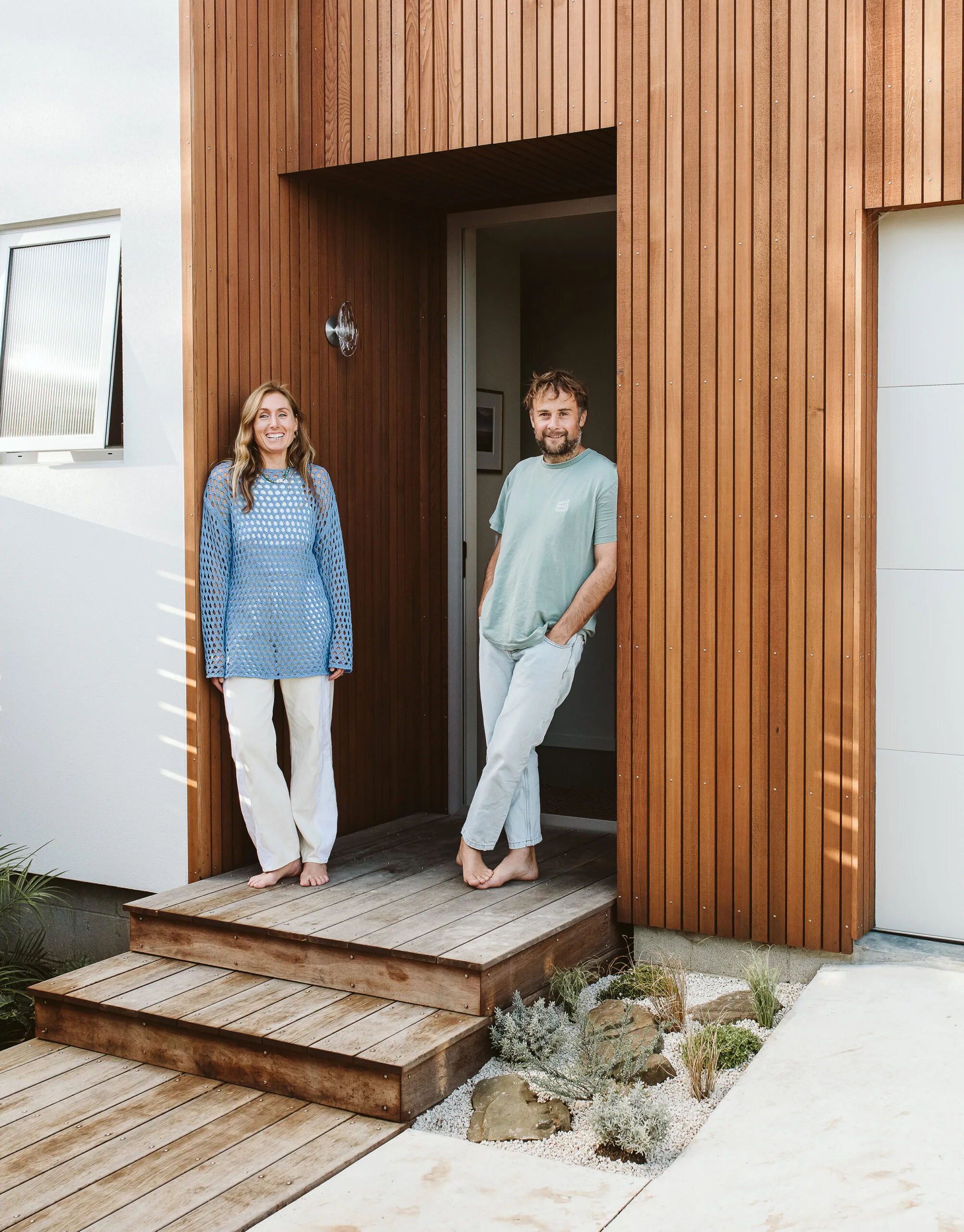 Homeowners in the doorway of their Taranaki home