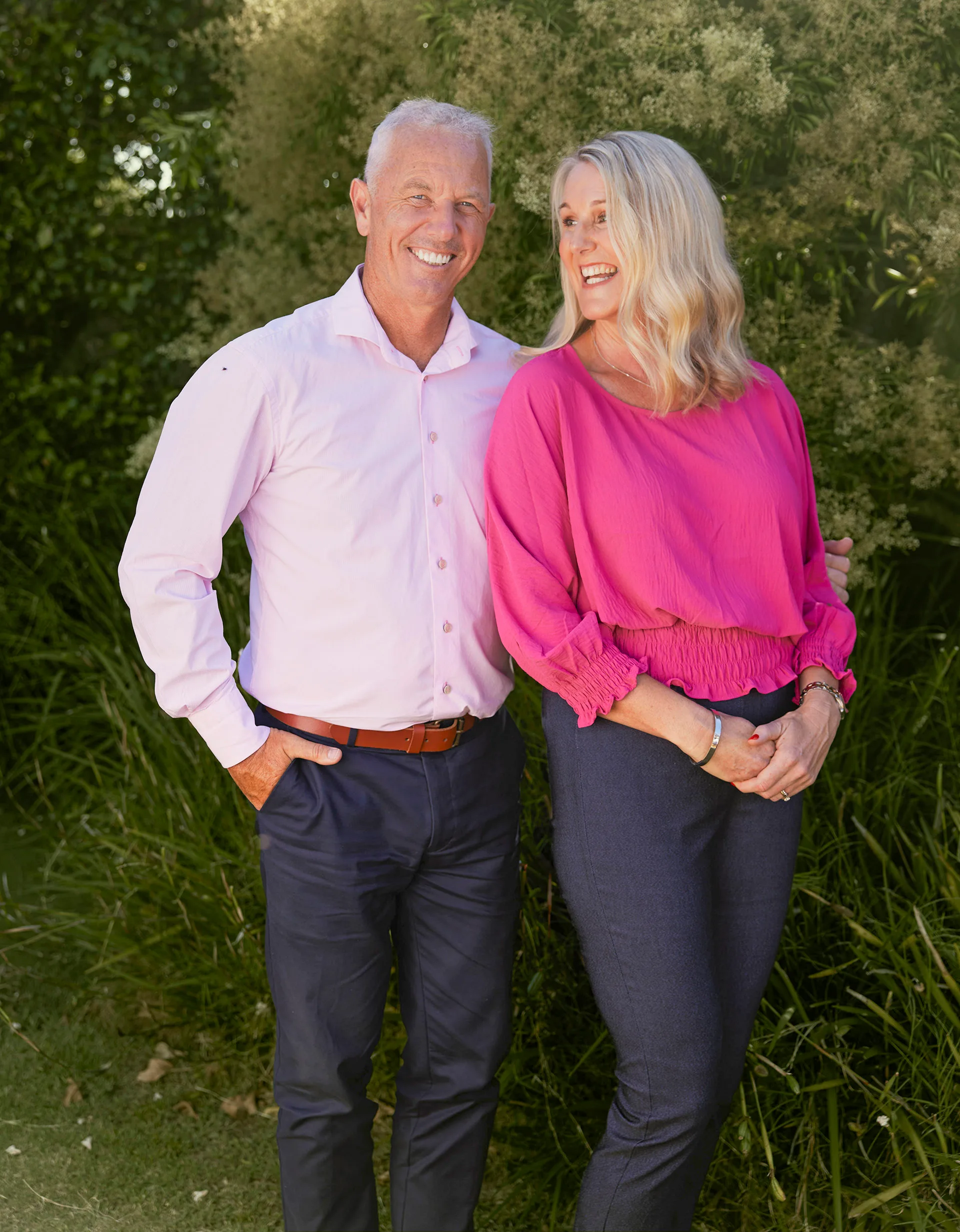 Mark Richardson and wife Mary posing in garden, Mary smiling at Mark