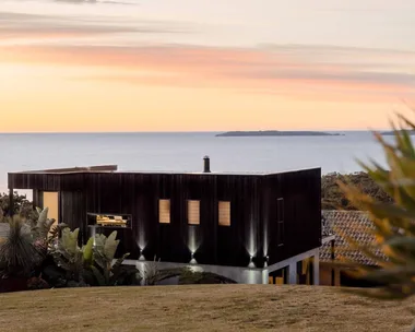 contemporary house overlooking the ocean at sunrise on the south coast