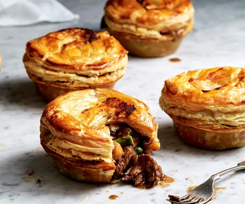 Our best savoury pie recipes. Image of Beef rendang pies with filling spilling out