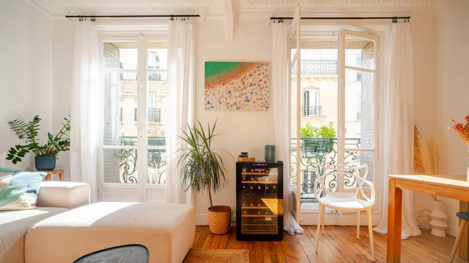 The living room with wine fridge and terrace of the apartment in Montmartre in Paris