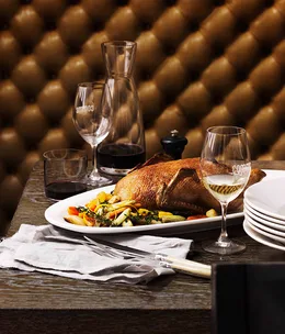 Whole roast duck with winter vegetables and orange