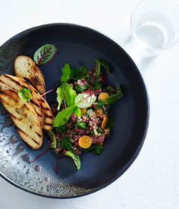 Raw flank steak, pickled carrots and salsa verde