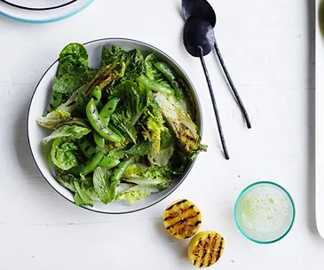 Charred lettuce and pea salad with charred lemon dressing