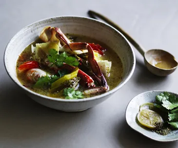 Crab soup with pickled vegetable and tomato