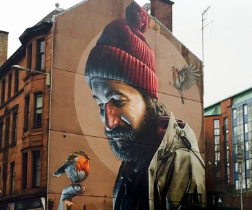 High Street mural of Saint Mungo by Sam Bates, aka Smug.