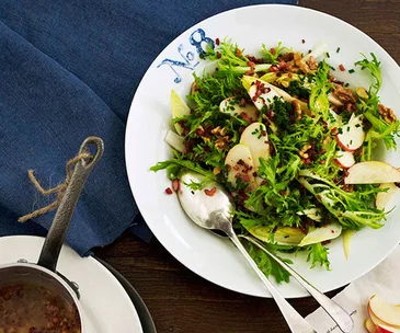 Frisée, witlof and apple salad with bacon bits and bacon fat dressing