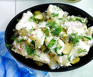 Old-school German-style crushed potato salad with dill pickles