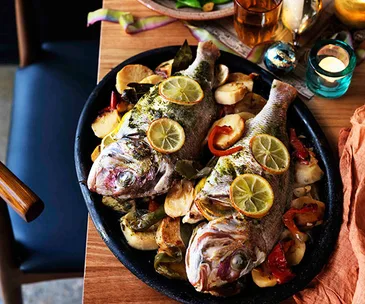 Marinated whole snapper baked on potatoes and peppers (Dorada al fondo con patatas)