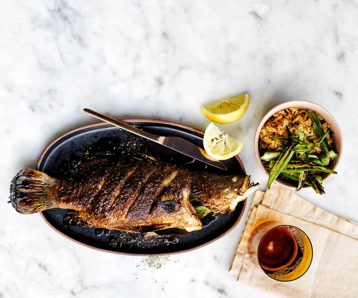 Whole barramundi with "dirty" rice.