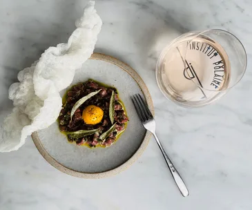 Institut Polaire restaurant and bar in Hobart Tasmania. Photo of wagyu tartare and glass of pale pink wine