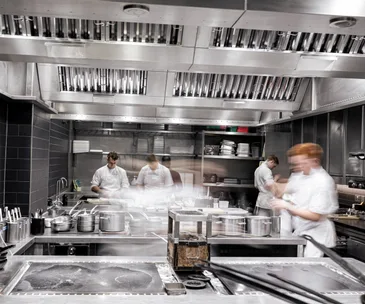 Four chefs working in the kitchen at Restaurant Gordon Ramsay in London, UK