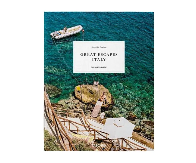 Cover of "Great Escapes Italy" book by Angelika Taschen featuring a serene coastal scene with clear blue water.