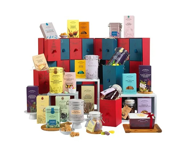 Colorful Fortnum & Mason luxury advent calendar with various festive treats in elegant packaging.