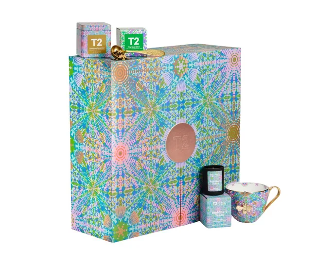Colorful T2 tea gift set with patterned box, two tea boxes, a golden spoon, and a decorative teacup.