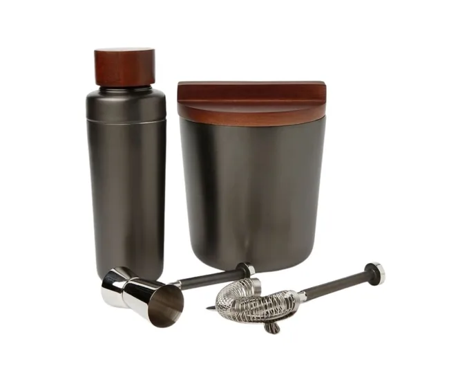 Bar tool set with a shaker, ice bucket, jigger, strainer, and muddler in black and wood finishes.