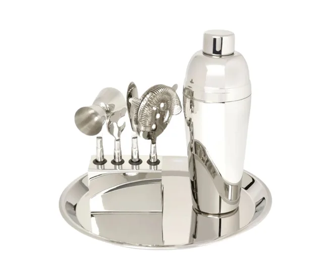Chrome cocktail shaker set with tools on a mirrored tray.