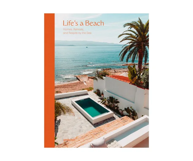Cover of "Life’s a Beach" book featuring a seaside view with pool, palm trees, and ocean.