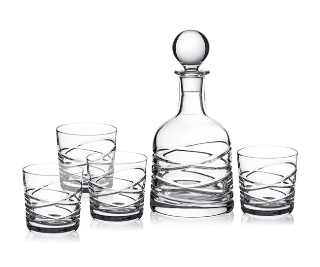 Glass decanter with a round stopper and four matching glasses, featuring a swirling design.