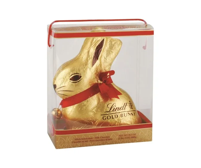 Gold-wrapped Lindt chocolate bunny with red ribbon in clear packaging, labeled "Lindt Gold Bunny."