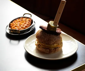 Clam Bar in Sydney CBD. Photo of its burger and honeycomb macaroni and cheese at Clam Bar in Sydney.