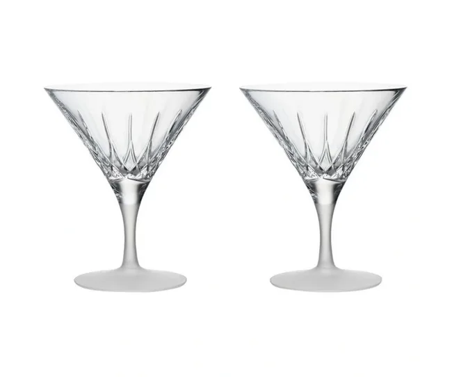 Two crystal martini glasses with etched detailing on a white background.