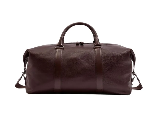 Brown leather duffel bag with handles and detachable shoulder strap.
