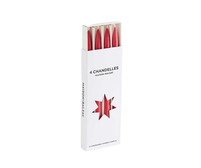 Box of 4 red Maison Balzac candles with a star-shaped window on the packaging.