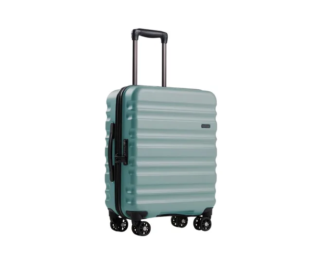 Green hard-shell suitcase with a telescopic handle and four wheels on a white background.