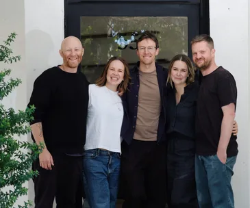 The core team of Brico - Phil Bracey, Tegan Ella Hendel, Simon Ball-Smith, Robyn Nethercote and Josh Begbie - stand outside the building smiling