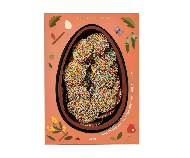 Koko Black chocolate egg with colorful sprinkles in illustrated packaging.