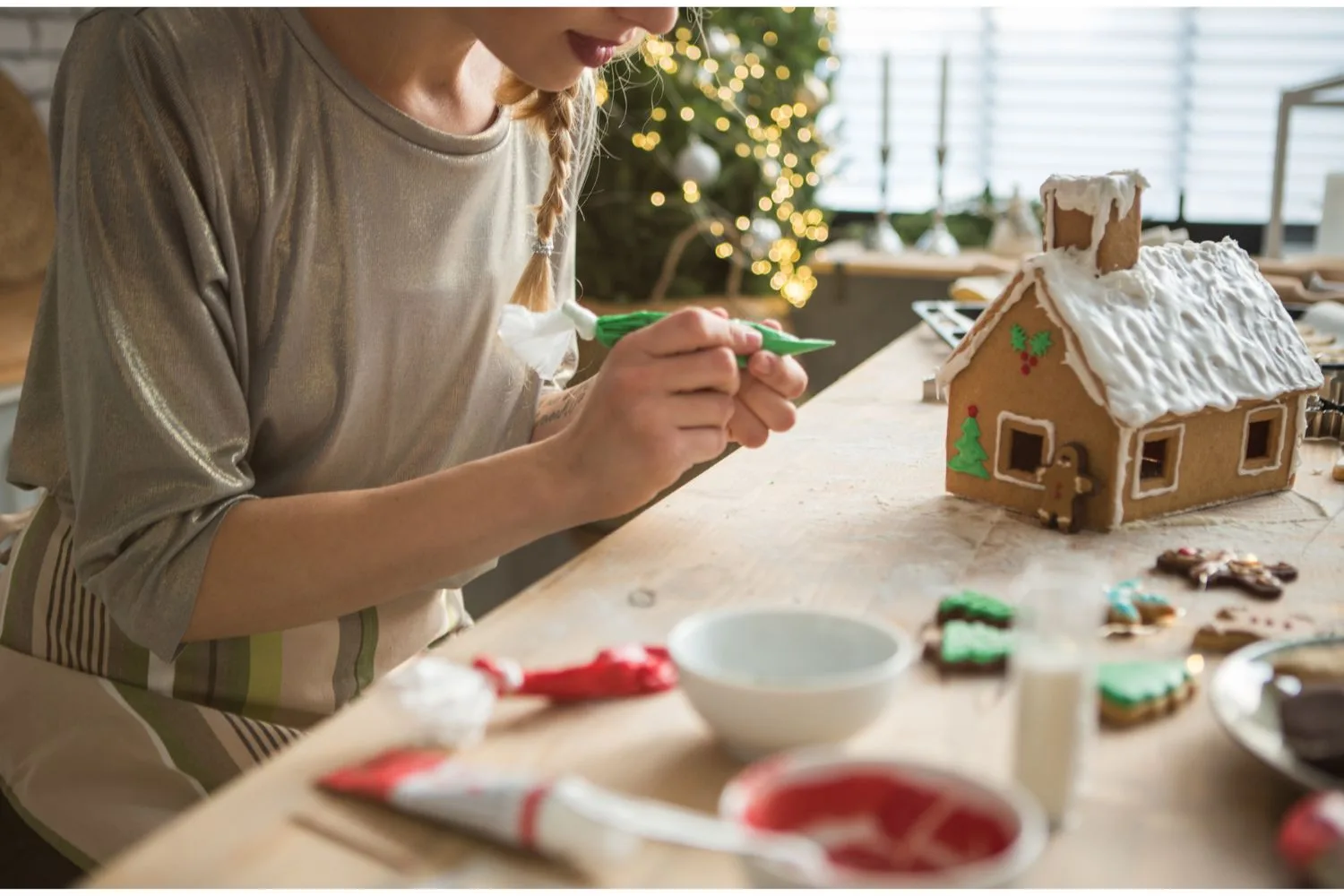 woman making gingerbread house