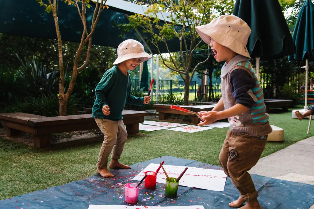 children painting outdoors