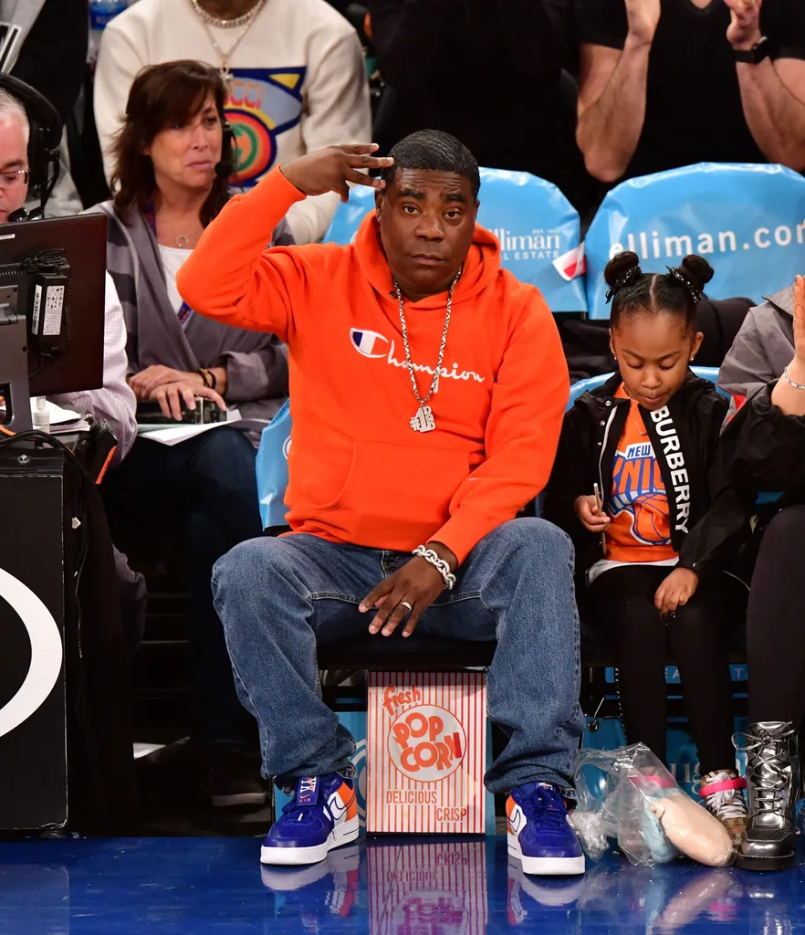 man at basketball game wearing champion hoodie