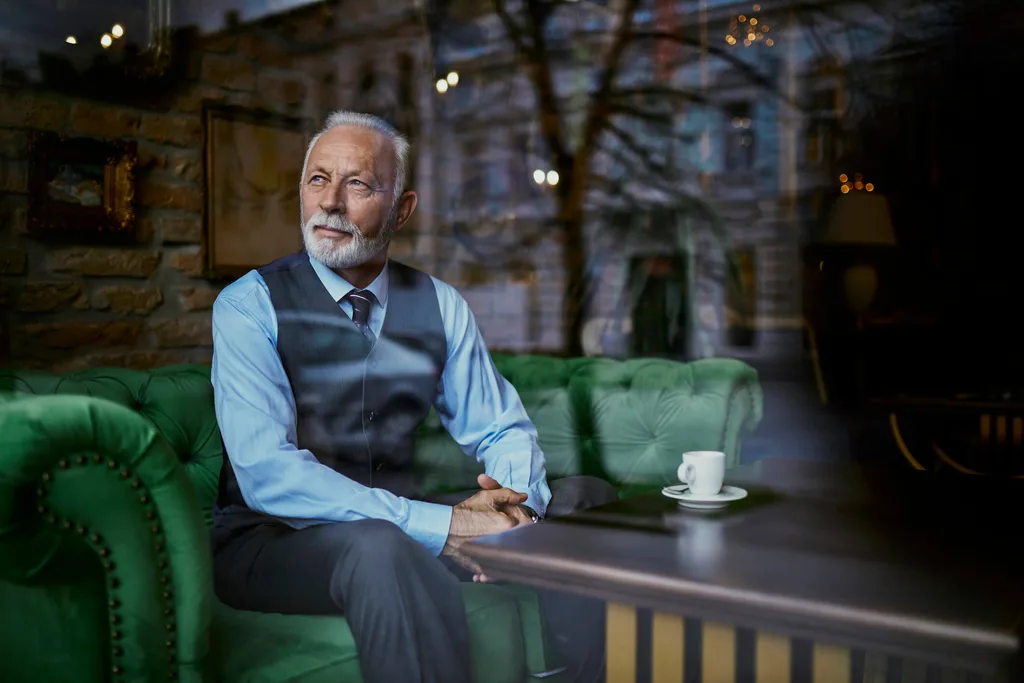 Man sitting on sofa and looking out window