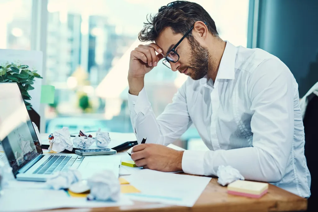 Guy writing notes on a notepad