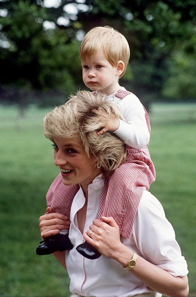 Princess Diana with Prince Harry on her shoulders