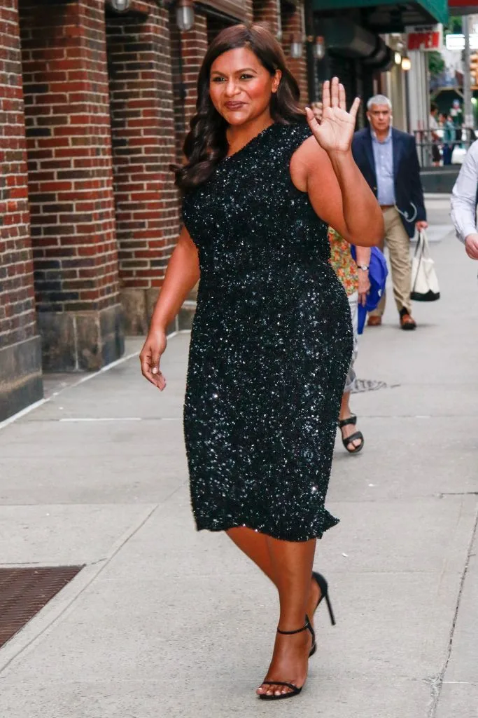 Mindy Kaling in a black shimmery dress on the streets of New York City