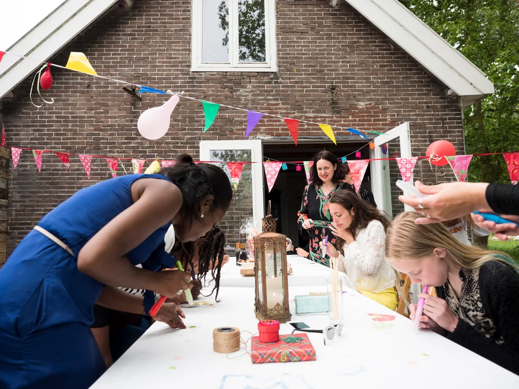 Girls helping setup birthday decorations