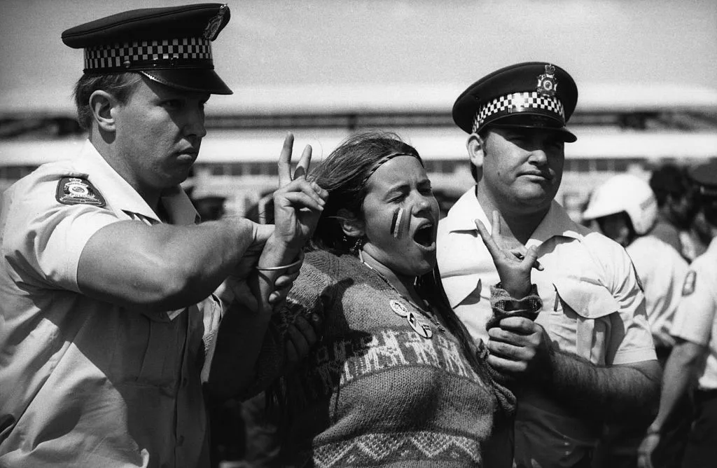 Australian police restraining and arresting woman