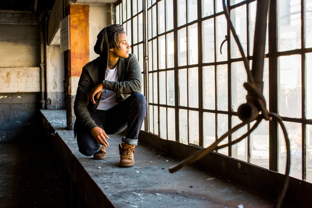 A person looking out the window of an abandoned building